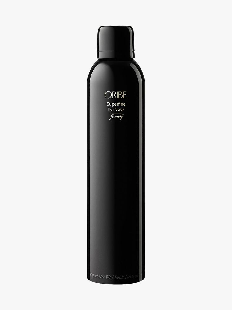 Oribe Superfine Hairspray black aerosol spray bottle on light gray background